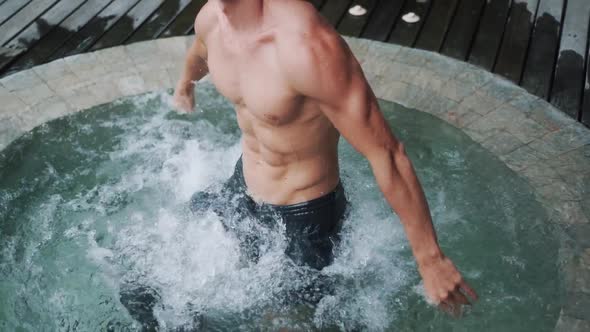 Handsome Man with Muscular Body Relaxes and Enjoys in Jacuzzi Slow Motion