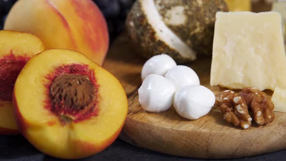 Cheese and Fruits on a Wooden Board