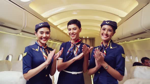 Cabin Crew Clapping Hands in Airplane