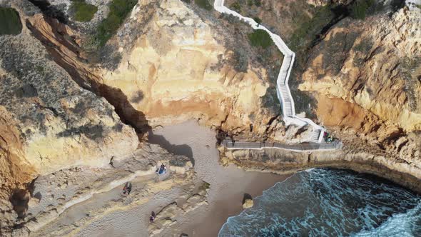 Downhill path through rocky cliff to Paradise Beach, in Carvoeiro, Algarve, Portugal