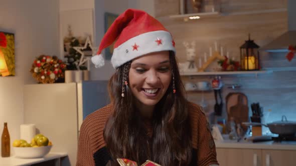 Festive Woman with Santa Hat Receiving Gift