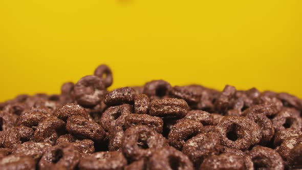 Falling Cereal Against Yellow Background
