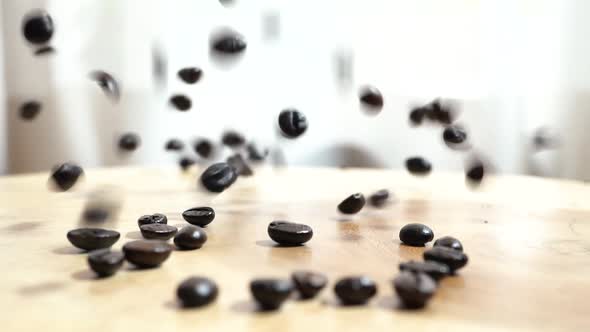 Rain of Freshly Roasted Coffee Beans Falling on Pile