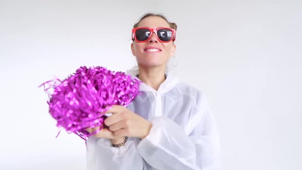 A Joyful Female with Red Glasses Dancing with Pompoms on a White Background