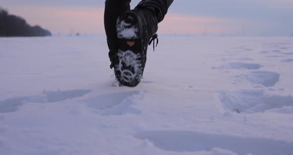 Male Legs Going in a Snowy Field