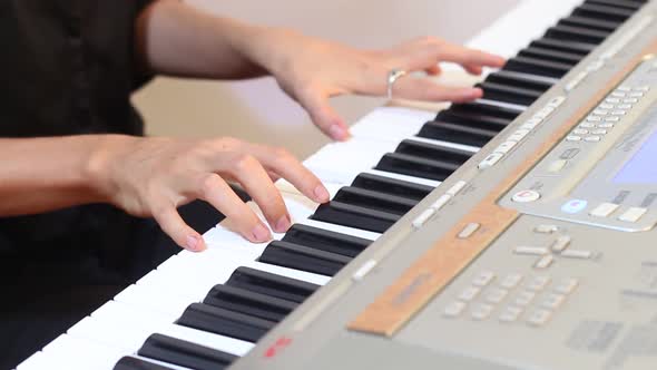 Womanl Playing on Electric Piano