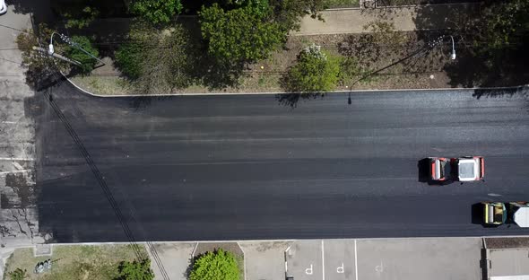 Aerial Top Down View of Asphalting Construction Works with Commercial Repair Equipment Road Roller