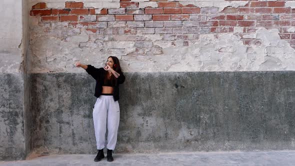 Woman with headphones dancing to music she is listening to