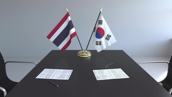 Flags of Thailand and South Korea on the Table