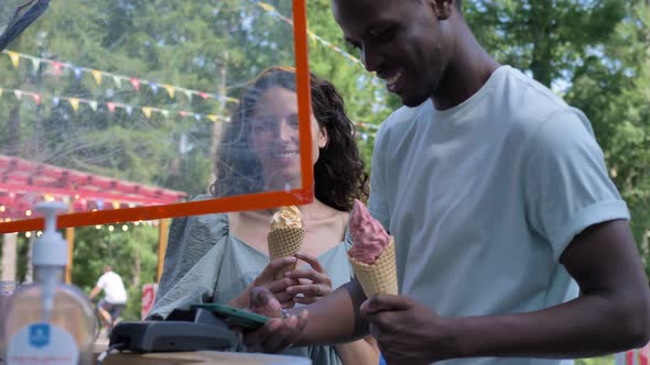 Black Man Pays for Icecream with Phone Talking to Brunette