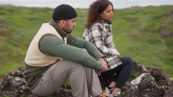 Couple Sitting Together On Rocks In Thingvellir