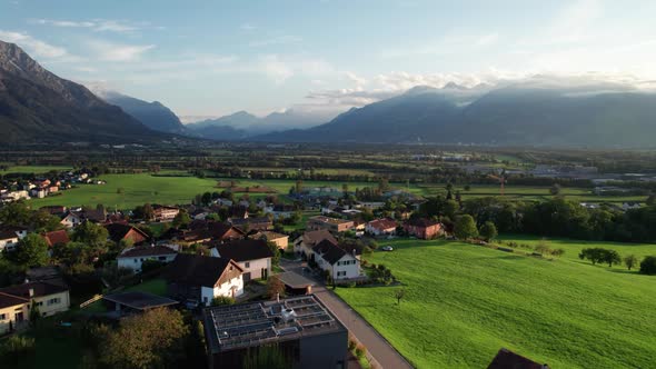 Aerial View of Liechtenstein with Houses on Green Fields in Alps Mountain Valley