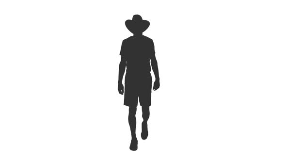 Silhouette of Man Tourist Walking in Shorts and Cowboy Hat