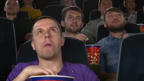 Young Mans Watching Movie at Cinema: Comedy. Close Up