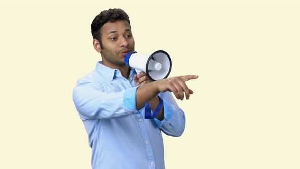 Man Talking Into Megaphone and Pointing with Index Finger