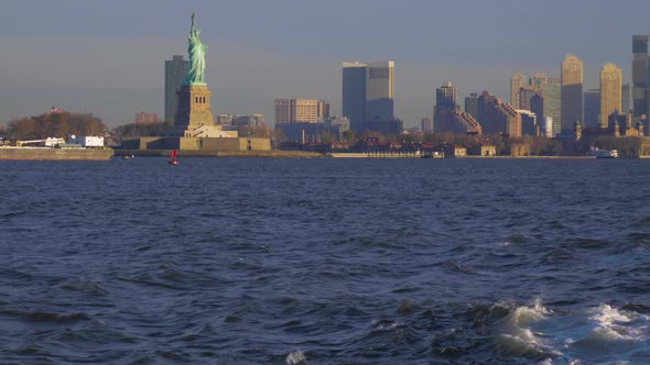 Statue of Liberty and Urban Cityscape in the Morning. New York City. View From the Water