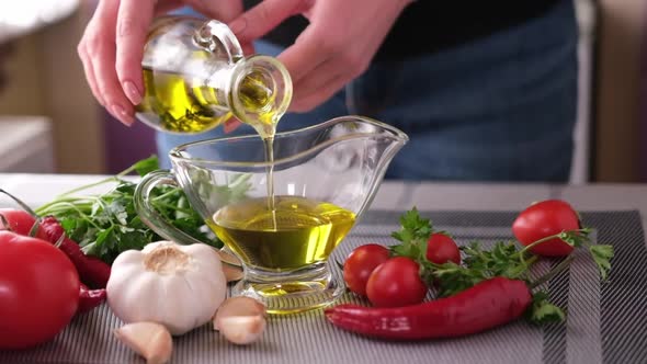 Making Garlic Sauce  Pouring Olive Oil Into Glass Gravy Boat