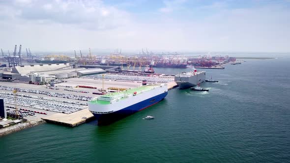 Aerial view of logistics concept of commercial vehicles, cars and pickup trucks waiting to be load o