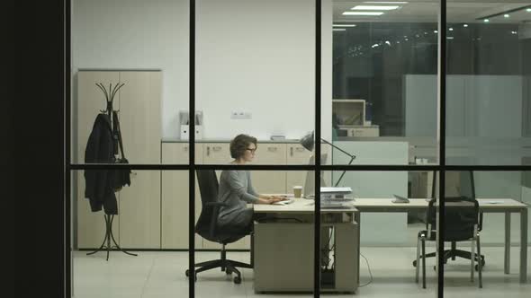 Businesswoman Working Night Shift in Office