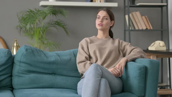 Woman Thinking While Sitting on Sofa