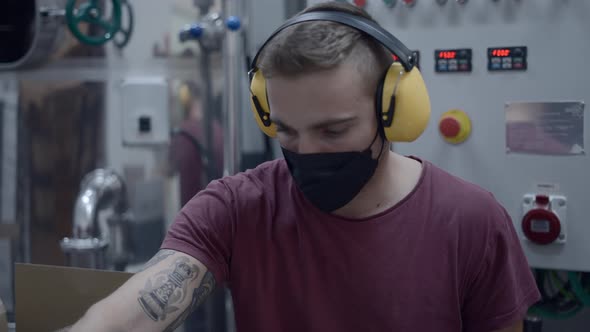 Male Worker Packing Cans Of Beer In A Brewery  Medium Shot