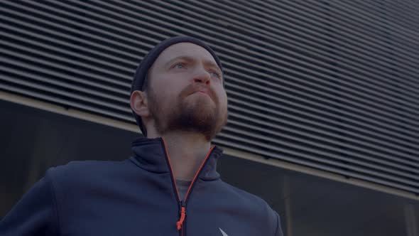 Portrait of Man Beard Looking Thoughtfully Into Distance on Gray Background