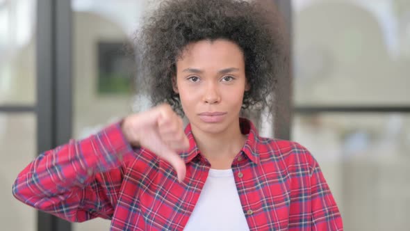 Portrait of African Woman Showing Thumbs Down Gesture