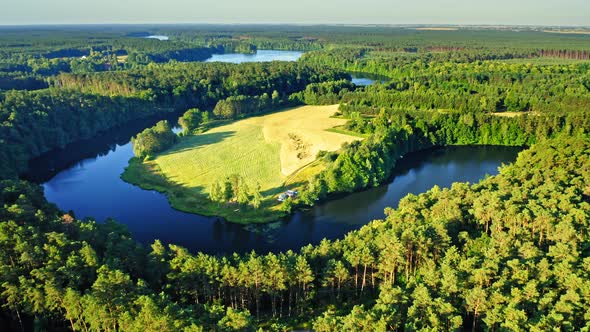 Blue curvy river and green forests in summer, Poland