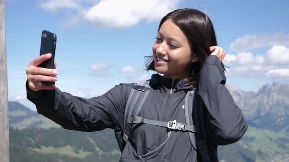 Female Hiker Taking Selfie on Scenic Overlook in Switzerland Mountains