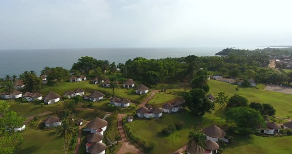 Closing in aerial shot of a beach resort in Mermaids Bay in Southwest Ivory Coast San Pedro Africa
