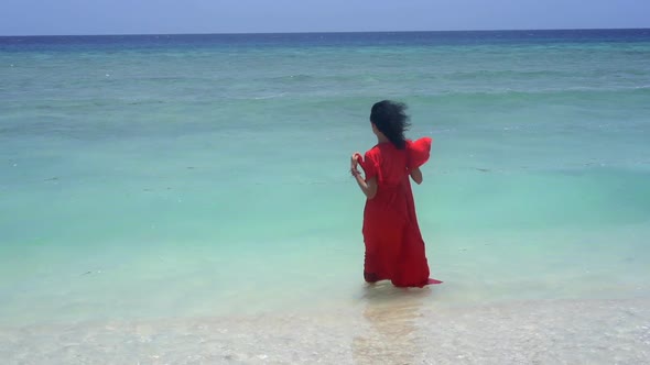 Charming Scenery of Beautiful Lady in Evening Dress Entering the Turquoise Sea Water Beauty in