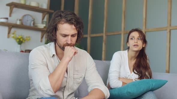 Couple Quarreling Sitting on the Couch at Home, Girlfriend Screams