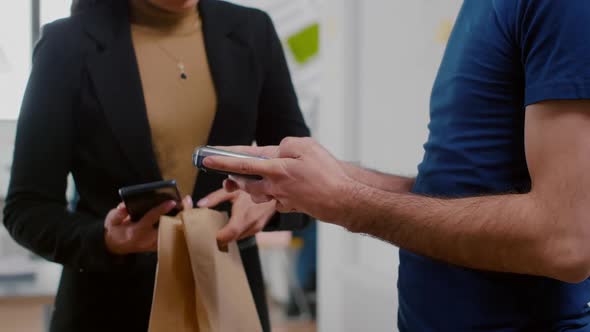 Closeup of Delivery Man Holding Takeaway Food Order Meal Bringing at Company Office