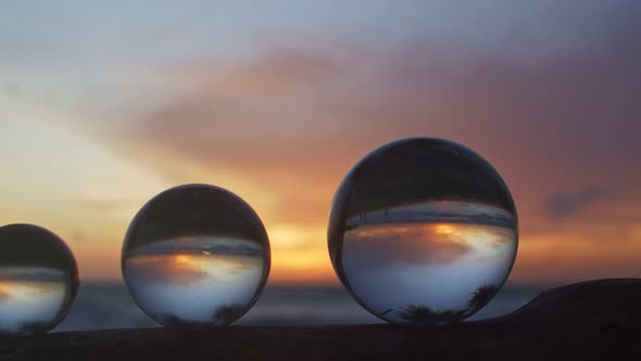 Scenery Sunset Inside Crystal Balls On A Timber.