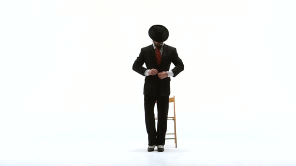 Elegant Man in a Black Hat Is Dancing an Erotic Dance. He Uses a Chair and a Cigarette. White