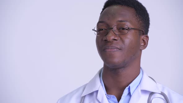 Face of Young Happy African Man Doctor Thinking