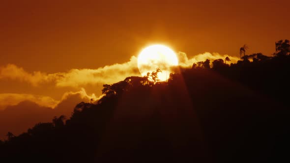 Sun Rises in the Morning Sky Over the Hill with Trees