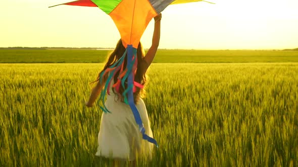 Girl Running Around with a Kite on the Field.