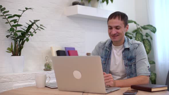 Technology Remote Job and Lifestyle Concept  Happy Man with Laptop Computer Having Video Chat