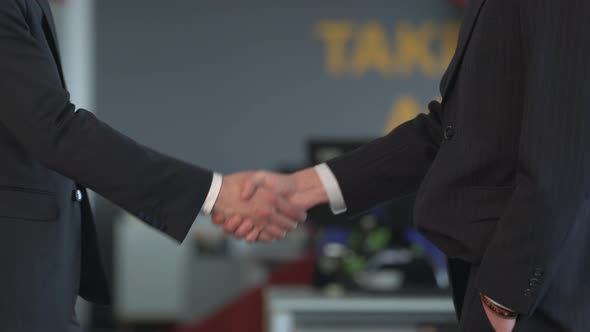 Businessmen shaking hands and walking