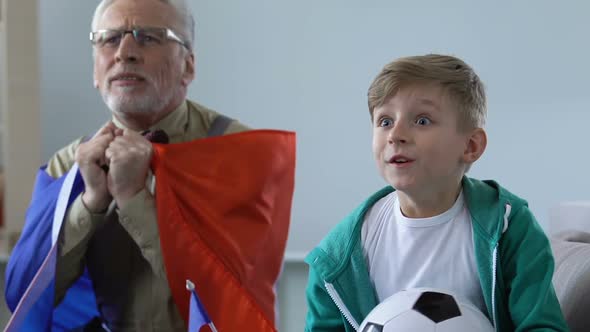 Grandfather and Grandson Watching Football Together, Happy German Fans Yelling