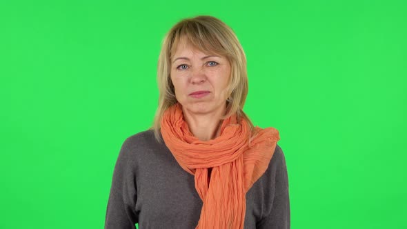 Portrait of Middle Aged Blonde Woman Negatively Waving Her Head. Green Screen