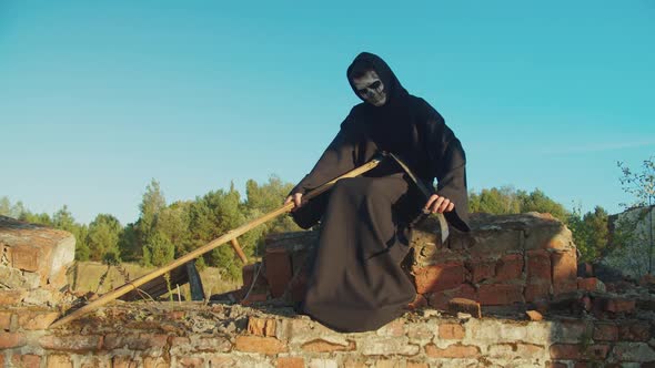 Grim Reaper Sharpening Rustic Scythe at Sunset