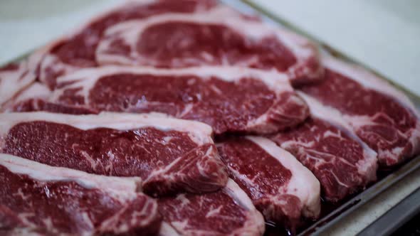 raw beef before grilling rosemary and garlic