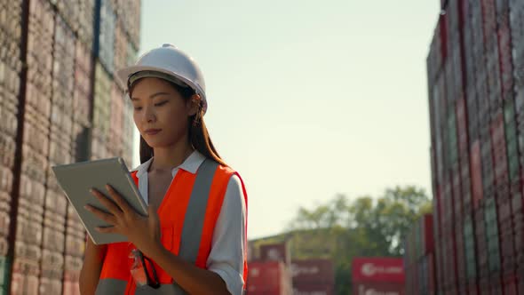 Asian engineer Foreman female worker working checking at Container cargo