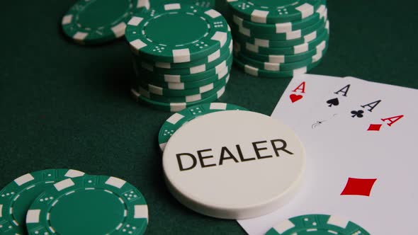 Rotating shot of poker cards and poker chips on a green felt surface - POKER 004