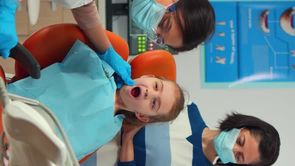 Vertical Video Stomatologist Doctor Checking Tooth Health of Young Patient