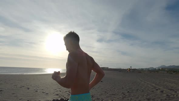 One young man running and enjoying summer in a beach alone with sunset