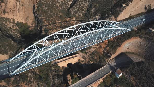 Aerial view of a modern bridge on top of another two older bridges from different periods. Older one