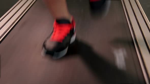 Woman's Feet Wearing Nice Sports Shoes Running Fast on Treadmill. Goal Pursuit
